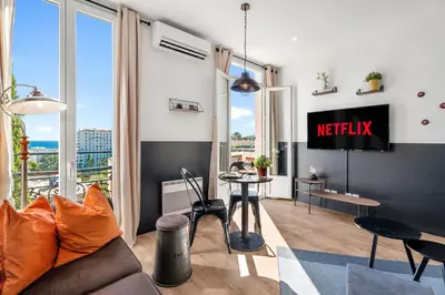 a living room with a couch and a table at Nice Renting - CAMBRAI - Luxurious Sea View Terrasse - King Bed - Parking - AC - fully equipped in Nice