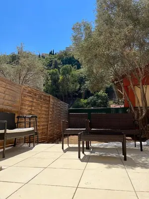 three benches sitting on a patio with a fence at Ninon in Nice