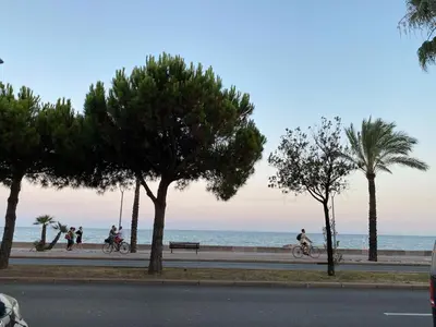 a group of people riding bikes on the beach at Coquet logement front de mer in Cagnes-sur-Mer