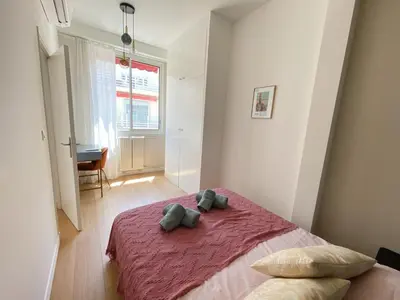 a bedroom with a bed with two pillows on it at Mediterranee - un trois pièces à deux pas de la plage in Nice