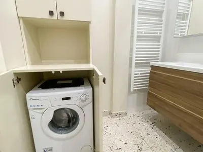 a small laundry room with a washer and dryer at Mediterranee - un trois pièces à deux pas de la plage in Nice