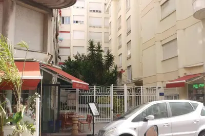 a white car parked in front of a building at Mediterranee - un trois pièces à deux pas de la plage in Nice
