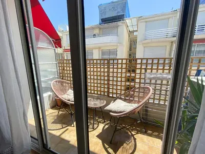 a balcony with two chairs and a table at Mediterranee - un trois pièces à deux pas de la plage in Nice