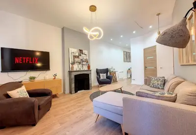 a living room with a couch and a tv at Nestor&Jeeves - LE PIERLAS - Place Garibaldi - Very close Old Town in Nice