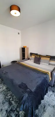 a bedroom with a bed with a blue comforter at Lovely 1 bedroom vacation home with free parking. in Nice