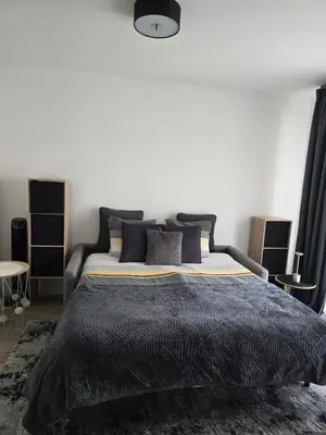 a bedroom with a bed with a black and white comforter at Lovely 1 bedroom vacation home with free parking. in Nice