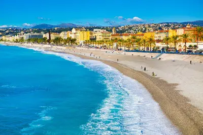 an aerial view of a beach with palm trees and buildings at LE 323 PROM - BEACHFRONT - PARKING - NEAR TRAM &SUPERMARKET - AC - washing machine in Nice