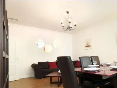 a dining room with a table and a couch at Nice - Paillon apartment by Stay in the heart of ... in Nice