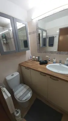 a bathroom with a toilet and a sink and a mirror at Appartement 2 pièces Nice in Nice