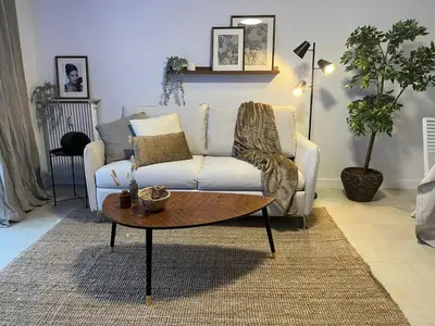 a living room with a couch and a coffee table at PALAIS ROYAL - Appartement tout confort in Nice