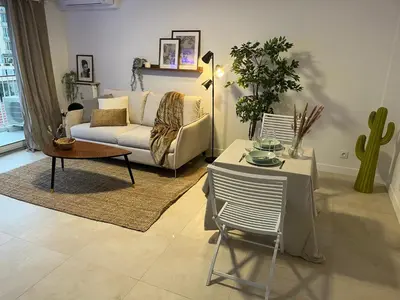 a living room with a couch and a table at PALAIS ROYAL - Appartement tout confort in Nice