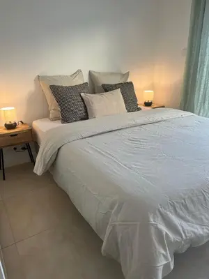 a bedroom with a large bed with pillows on it at PALAIS ROYAL - Appartement tout confort in Nice