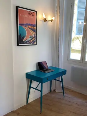 a blue desk with a laptop on it in a room at Old Town Nice Renovated 2BR Near Beaches & Cours Saleya in Nice