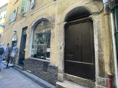 a store front with a black door on a street at Old Town Nice Renovated 2BR Near Beaches & Cours Saleya in Nice