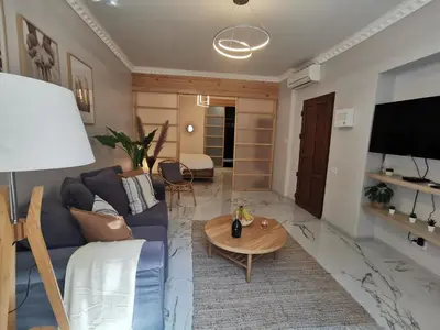 a living room with a blue couch and a table at Proche mer, vieille ville. Luxueux appartement in Villefranche-sur-Mer