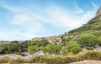 a town on a hill with trees and cars at Nice Home In Saint-Jeannet in Saint-Jeannet