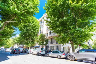 a row of cars parked on a city street with trees at COSY GARNIER AP4281 by Riviera Holiday Homes in Nice