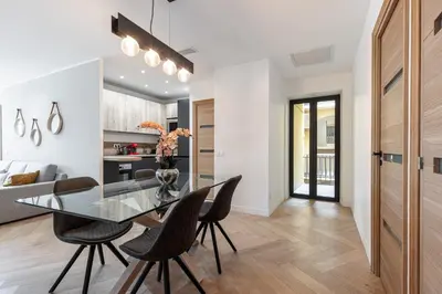 a dining room and kitchen with a glass table and chairs at Magnifique appartement, Nice Centre Ville - Masséna in Nice