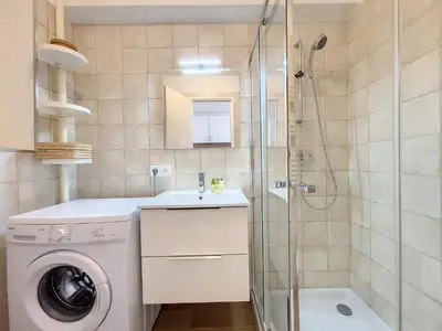 a bathroom with a washing machine and a shower at Nestor&Jeeves - THAIS BEACH - Central - Very close sea - Pedestrian zone in Nice