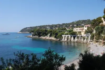 a view of a beach with people in the water at 2P neuf au Coeur de St Jean Cap Ferrat in Saint-Jean-Cap-Ferrat