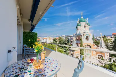 a table on a balcony with a view of a building at Imperial AP4318 by Riviera Holiday Homes in Nice