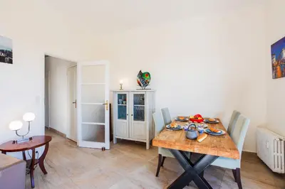 a dining room with a wooden table and chairs at Imperial AP4318 by Riviera Holiday Homes in Nice