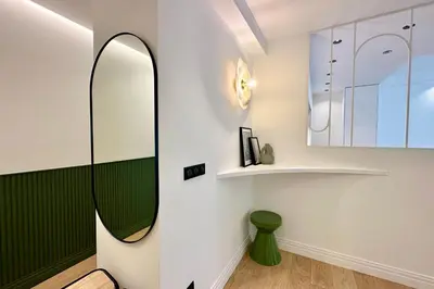 a bathroom with a mirror and a green stool at OPERA PROMENADE 4 Renovated 3 Bedrooms Balcony Sea View AC in Nice