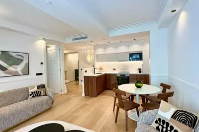 a living room with a couch and a table at OPERA PROMENADE 4 Renovated 3 Bedrooms Balcony Sea View AC in Nice
