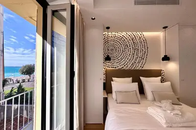 a bedroom with a bed with a view of the ocean at OPERA PROMENADE 4 Renovated 3 Bedrooms Balcony Sea View AC in Nice