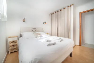 a bedroom with a white bed with towels on it at Charming Villa Saint-Jean-Cap-Ferrat in Saint-Jean-Cap-Ferrat