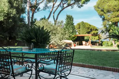 a patio with a table and chairs in a yard at Charming Villa Saint-Jean-Cap-Ferrat in Saint-Jean-Cap-Ferrat