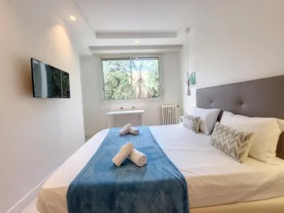 a bedroom with a bed with two towels on it at Nestor&Jeeves - ANGLICAN TERRASSE - Central - Very close sea in Nice