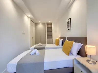 two beds in a room with white walls and yellow pillows at Nestor&Jeeves - ANGLICAN TERRASSE - Central - Very close sea in Nice