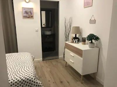 a bedroom with a bed and a dresser with a lamp at Nice, Seaside apartment in Nice