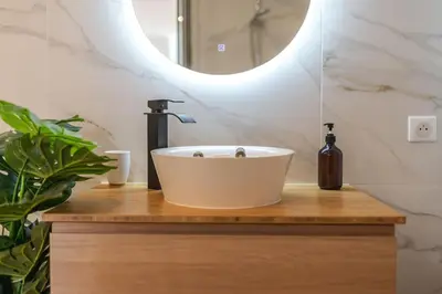 a bathroom with a white sink and a mirror at A/C & BALNEO in of Carré d'Or NICE #RENOVATED in Nice