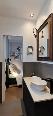 a bathroom with a sink and a mirror and a bed at Exceptional brand new flat, 20 m from beach, 85 sq in Nice