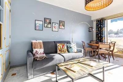 a living room with a couch and a table at Eat - Sleep - Wander Chic and Cosy Flat in Nice
