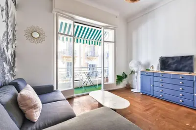 a living room with a couch and a tv at Magnificent apartment - Carré d'or in Nice