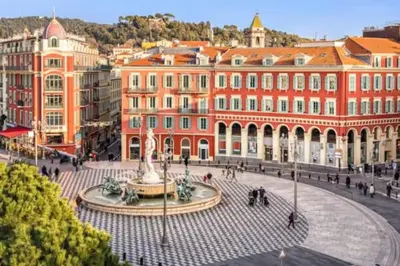 a city with a fountain in front of a building at Magnificent apartment - Carré d'or in Nice