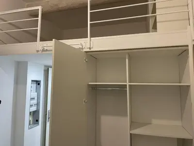 a room with white shelves and a bunk bed at Apart Nissa Bella Massena / Vieux Nice in Nice