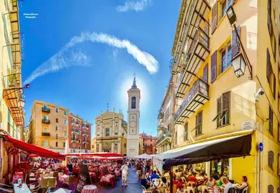 a city street with a clock tower in the distance at Apart Nissa Bella Massena / Vieux Nice in Nice