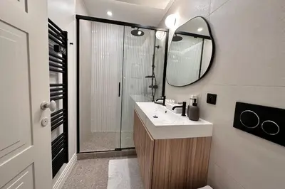 a bathroom with a sink and a shower with a mirror at OPERA PROMENADE 2 Renovated 1 min to Beach Air Conditioning in Nice