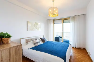 a bedroom with a bed with a blue blanket at LE SIRIUS AP4314 By Riviera Holiday Homes in Nice