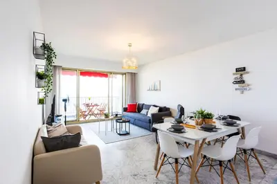 a living room with a table and a couch at LE SIRIUS AP4314 By Riviera Holiday Homes in Nice