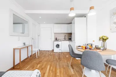 a kitchen and dining room with a table and chairs at MY CASA - JOFFRE 2 - Cosy apartment in City Center in Nice
