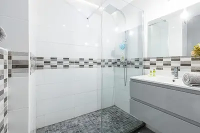 a white bathroom with a sink and a shower at MY CASA - JOFFRE 2 - Cosy apartment in City Center in Nice