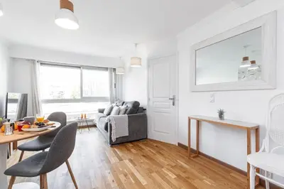 a living room with a table and a couch at MY CASA - JOFFRE 2 - Cosy apartment in City Center in Nice