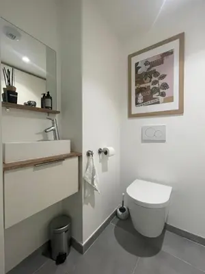a bathroom with a white toilet and a sink at Appartement de luxe Eze village vue mer avec piscine in Èze