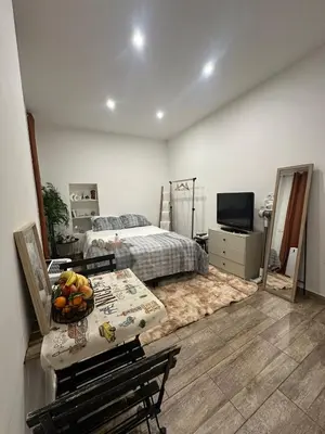 a bedroom with a bed and a table with a bowl of fruit at Cosy studio VIEUX NICE à 2 pas de la MER in Nice