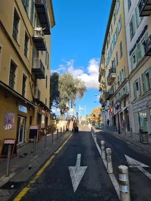 an empty city street with an arrow on the road at Cosy studio VIEUX NICE à 2 pas de la MER in Nice